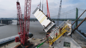 WHETHER BUILDING BRIDGES OR STEMMING FLOOD-WATERS, QCA WORKERS PUT THEIR BACKS INTO IT