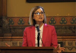 Gov Kim Reynolds signs health-insurance-premium tax increase into law