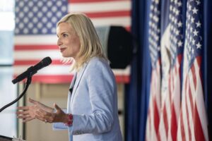 Hecklers disrupt rally for Rep Ashley Hinson as Senate candidate touts stock trading ban